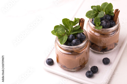 Cake dessert. Chocolate mousse with blueberry, mint and cinnamon