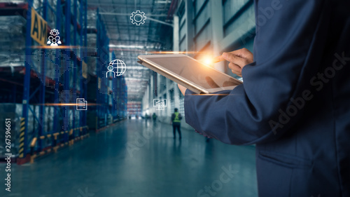Business Logistics concept, Businessman manager using tablet check and control for workers with Modern Trade warehouse logistics. Industry 4.0 concept