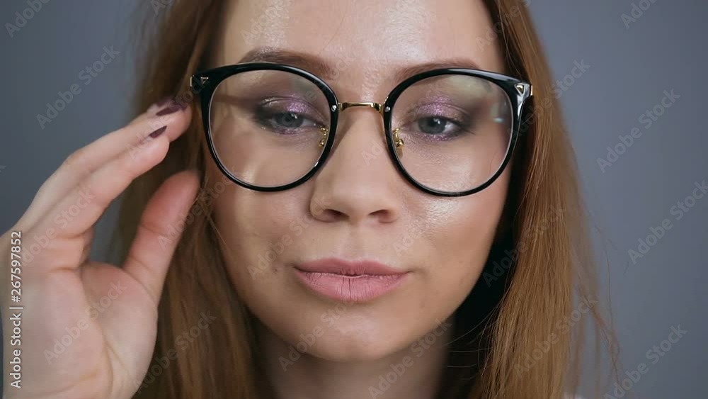 Young attractive female cosmetologist posing and looking at camera.