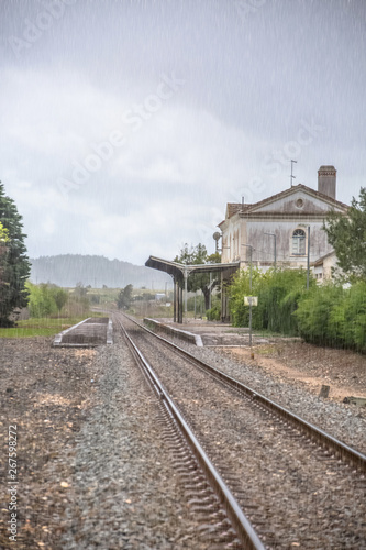 View of train line, rainy day, Obidos train station as background