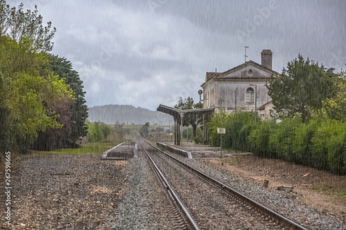 View of train line, rainy day, Obidos train station as background