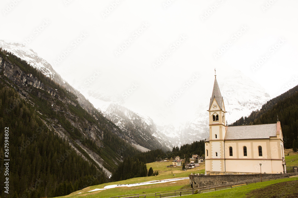 Beautiful mountain scenery in the Alps with fresh green meadows in bloom on a beautiful sunny day in springtime. Dolomiti montains in Italy. Landscape in spring in Europe