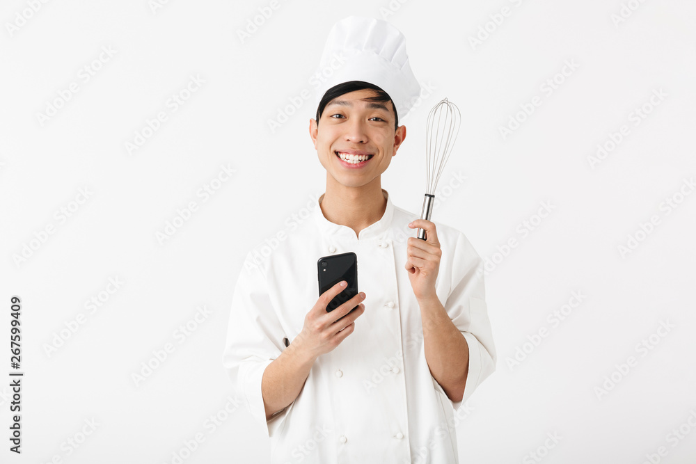 Excited asian chef wearing uniform standing Excited asian chef wearing uniform standing