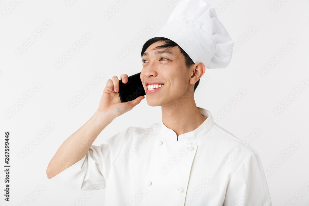 Excited asian chef wearing uniform standing Excited asian chef wearing uniform standing