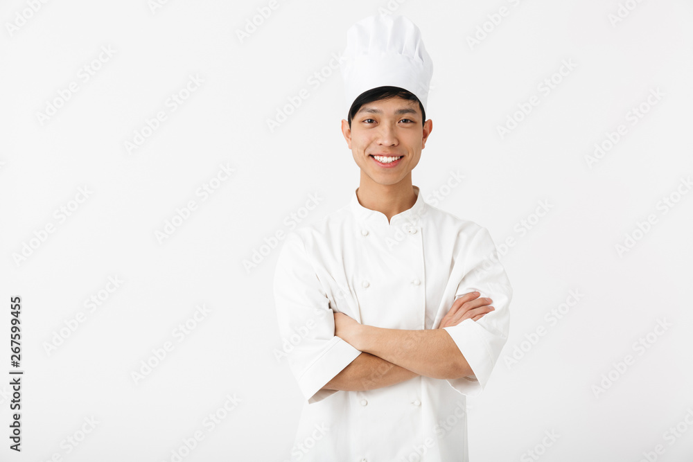 Excited asian chef wearing uniform standing Excited asian chef wearing uniform standing