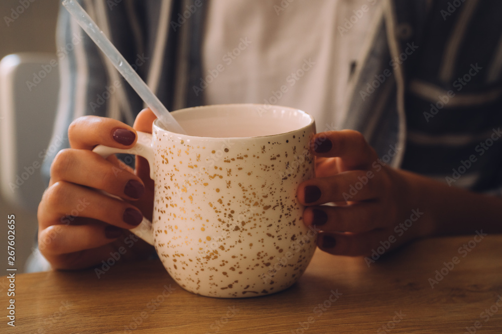 woman hands holding mug of hot drink that standing on wooden table woman hands holding mug of hot drink that standing on wooden table