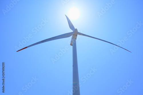 wind turbine on background of blue sky © Sally B