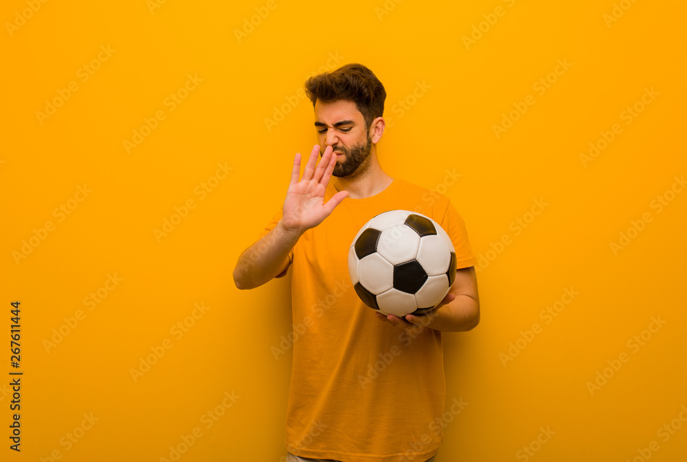 Young soccer player man putting hand in front Young soccer player man putting hand in front