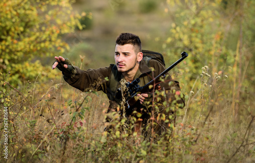 Hunting is brutal masculine hobby. Hunting and trapping seasons. Bearded serious hunter spend leisure hunting. Man wear camouflage clothes nature background. Hunting permit. Hunter hold rifle