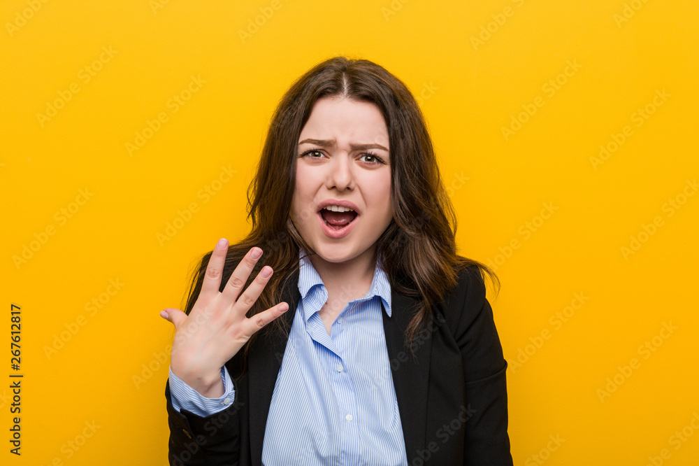 Young plus size caucasian business woman screaming with rage. Young plus size caucasian business woman screaming with rage.