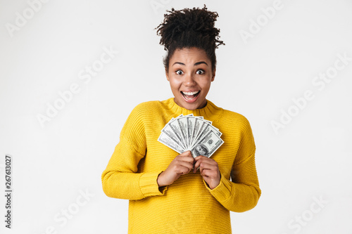 African excited emotional happy woman posing isolated over white wall background holding money.