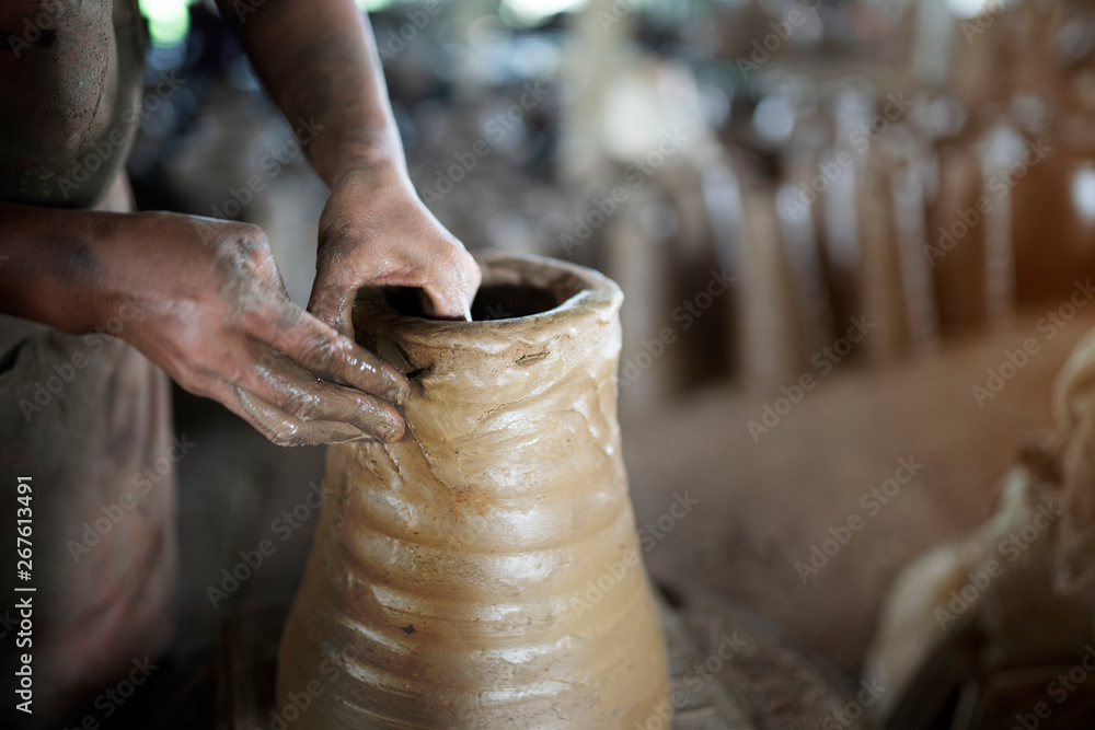 Close up hand making jar or vase,earthenware step
