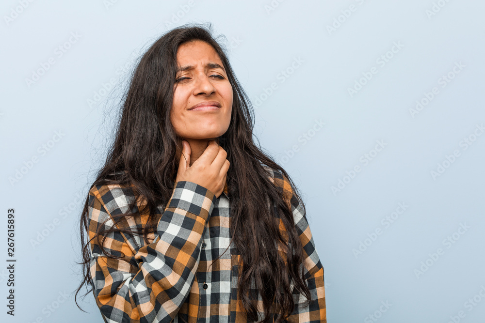 Young cool indian woman suffers pain in throat due a virus or infection. Young cool indian woman suffers pain in throat due a virus or infection.