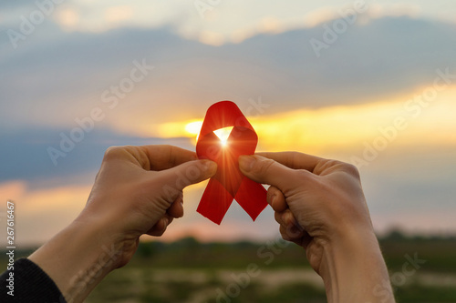 Canvas Print Aids red ribbon in hands .