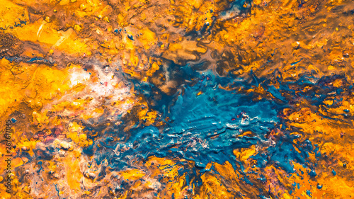 Abstract art texture background. Autumn forest sky design. Vibrant orange and blue paint splash.
