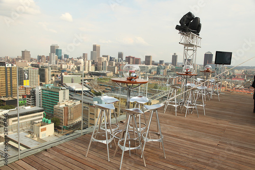rooftop patio setup with furniture and city scape at the back