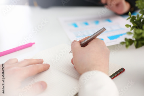 Group of people hold silver pen ready to make note in clipboard pad sheet closeup. Training course university practice homework school or college exercise secretary table management concept