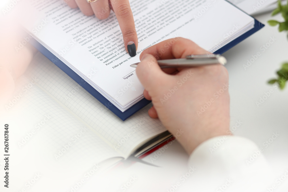 Arm fill and sign important form clipped to pad with silver pen closeup. Make note gesture read pact sale agent bank job loan credit mortgage investment finance chief legal law take part in campaign Arm fill and sign important form clipped to pad with silver pen closeup. Make note gesture read pact sale agent bank job loan credit mortgage investment finance chief legal law take part in campaign