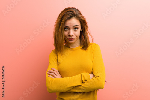 Young pretty young woman unhappy looking in camera with sarcastic expression. photo