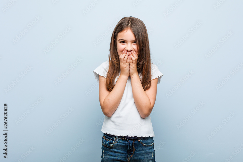Cute girl laughing about something, covering mouth with hands. Cute girl laughing about something, covering mouth with hands.
