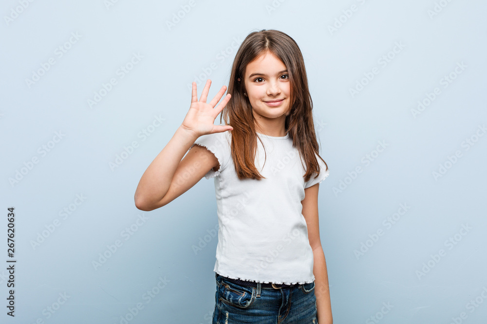 Cute girl smiling cheerful showing number five with fingers. Cute girl smiling cheerful showing number five with fingers.