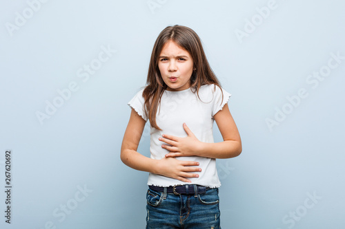 Cute girl sick, suffering from stomachache, painful disease concept.