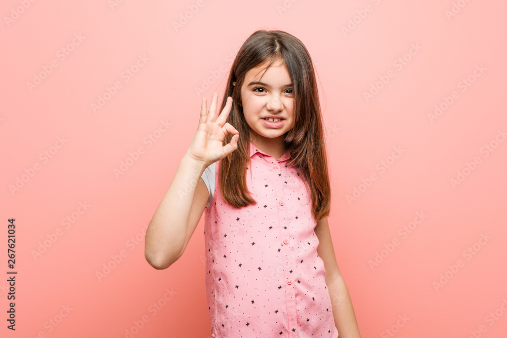 Cute little girl cheerful and confident showing ok gesture. Cute little girl cheerful and confident showing ok gesture.