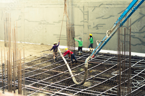 Construction worker Concrete pouring during commercial concreting floors  ,Beamless flooring system (Post-Tensioning Systems) photo