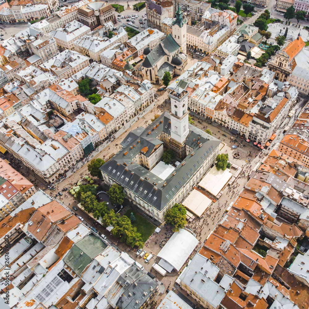 Fototapeta premium aerial view old european city with red roofs. city hall tower