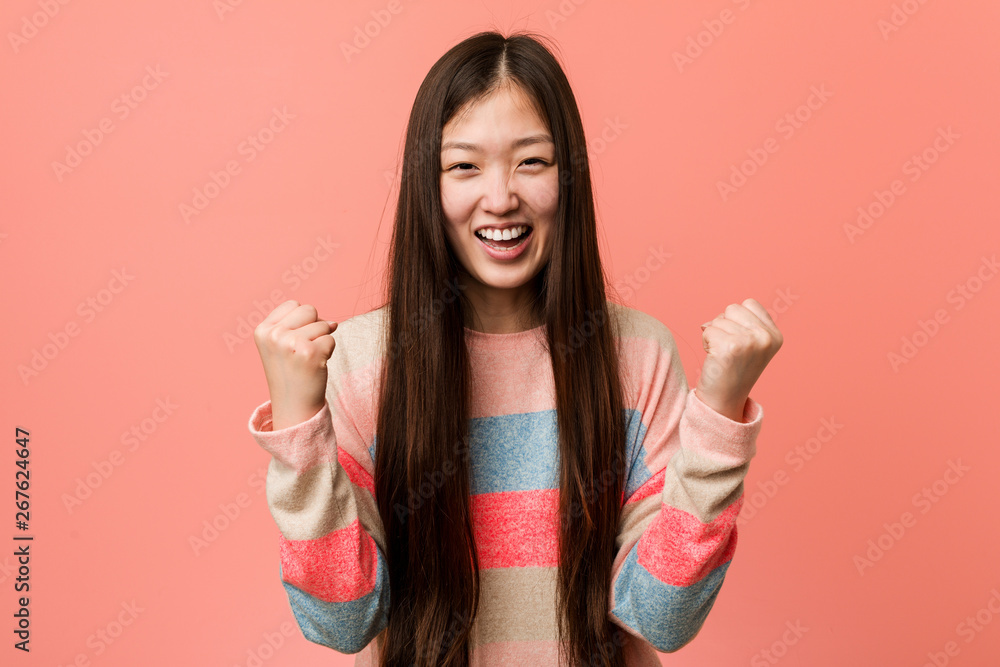 Young cool chinese woman cheering carefree and excited. Victory concept. Young cool chinese woman cheering carefree and excited. Victory concept.