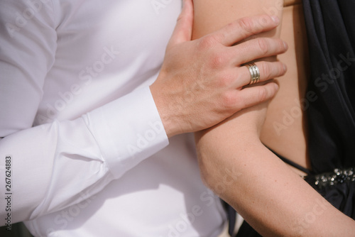 Man hugging a woman in a dress close-up