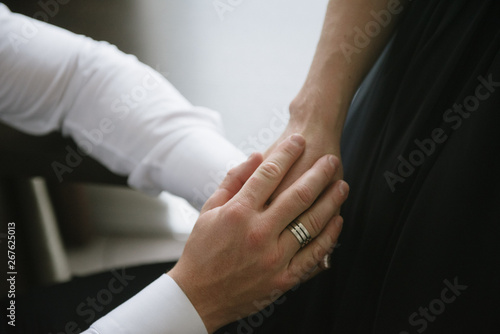 Man and woman hold hands close up