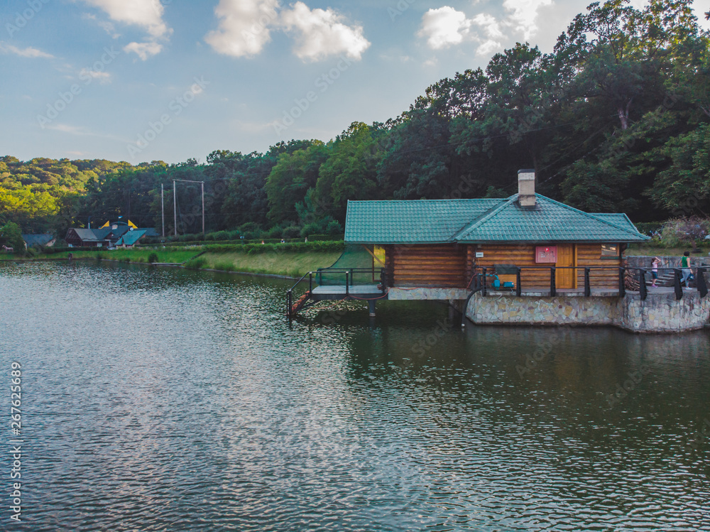 Fototapeta premium view of beautiful lake house. resort park near forest