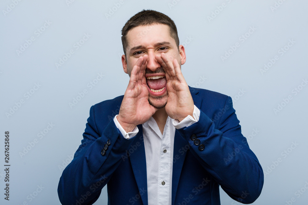 Young business caucasian man shouting excited to front. Young business caucasian man shouting excited to front.