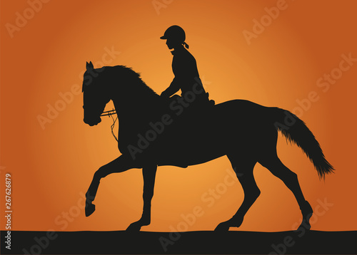 Silhouette rider on sunset background