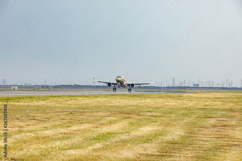 Green and white cargo plane lands on the runway. Green and white cargo plane lands on the runway.