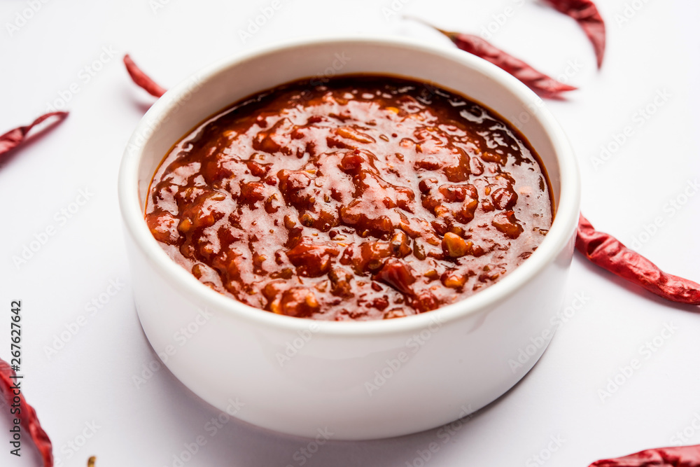 Schezwan Sauce / Szechuan chutney is an important ingredient in Chinese recipe. served in a bowl, isolated. selective focus Schezwan Sauce / Szechuan chutney is an important ingredient in Chinese recipe. served in a bowl, isolated. selective focus