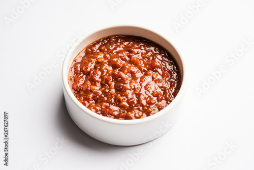 Schezwan Sauce / Szechuan chutney is an important ingredient in Chinese recipe. served in a bowl, isolated. selective focus