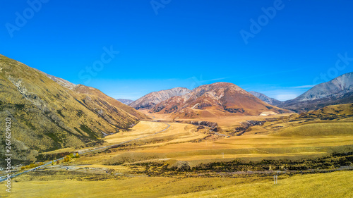 Farmland surrounded by mountains. West Coast, South Island, New Zealand
