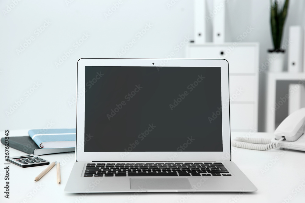 Stylish workplace with modern laptop on desk Stylish workplace with modern laptop on desk