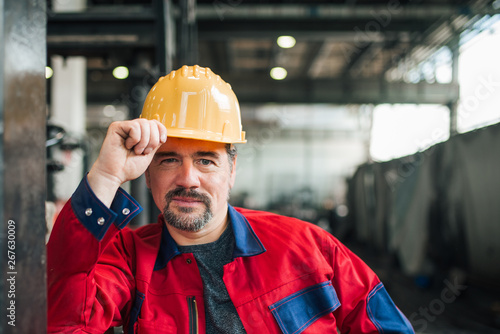 Portrait of a mature heavy industry worker at factory, head shot.