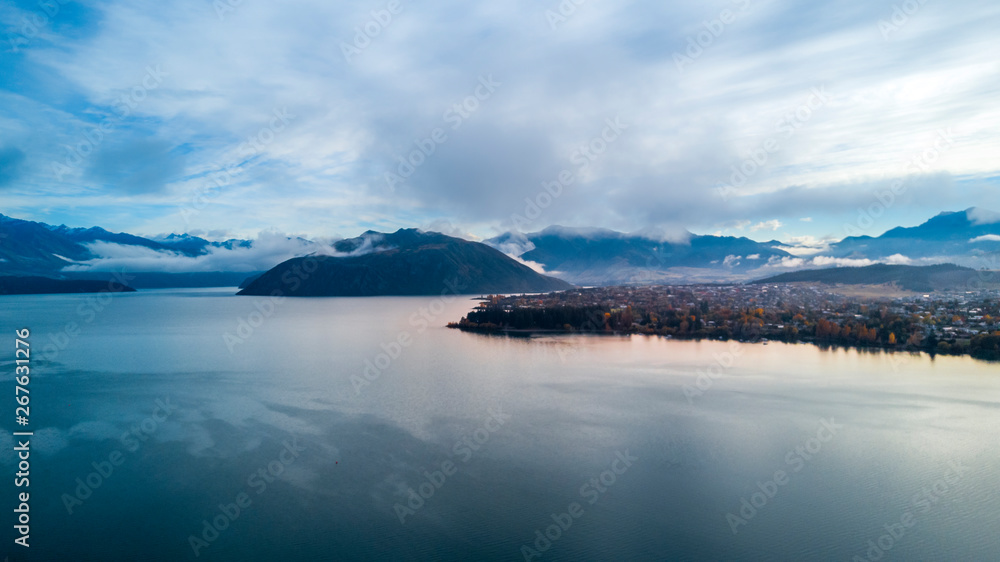 Naklejka premium Sunrise over pristine lake with mountains on the background. Wanaka, Otago, South Island, New Zealand