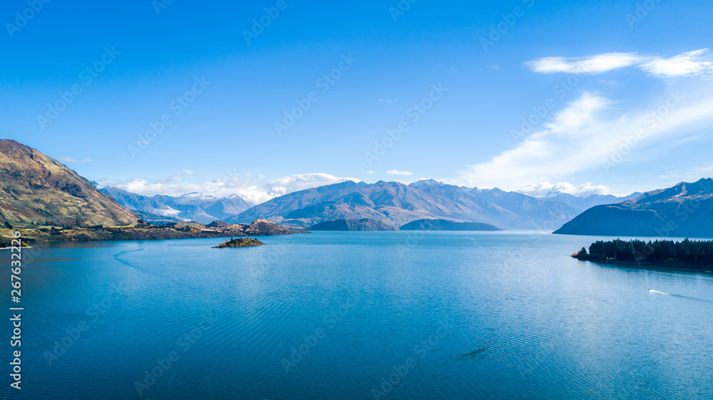 Pristine lake at a sunny day with mountains on the background. Wanaka, Otago, South Island, New Zealand