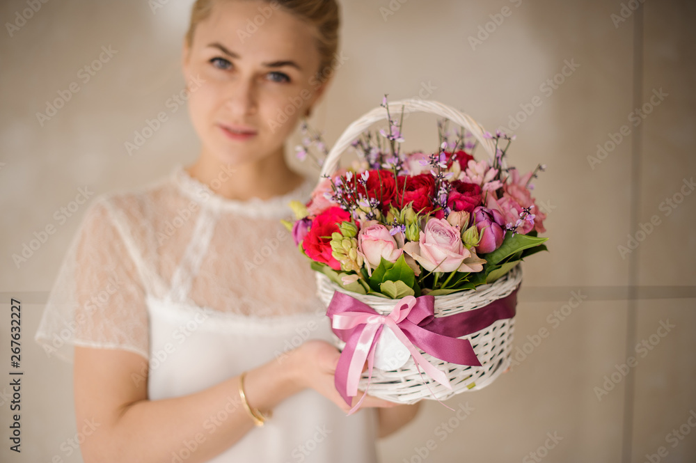 Young girl holding small basket with flowers Young girl holding small basket with flowers