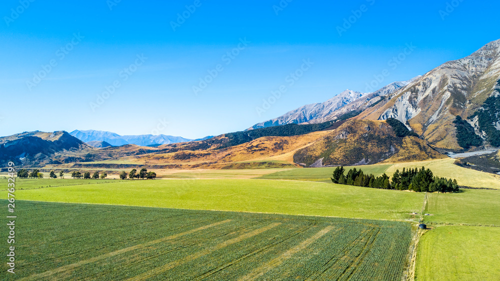 Mountains with farmland on the foreground. West Coast, South Island, New Zealand.