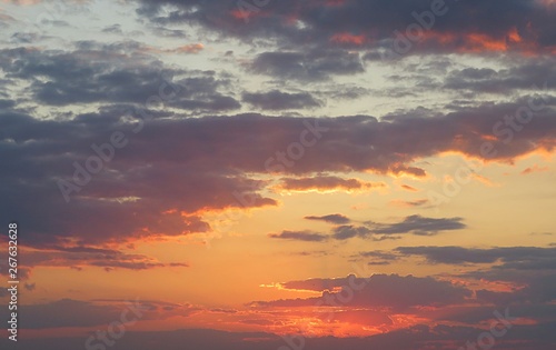 Beautiful orange burgundy sunset background over the field