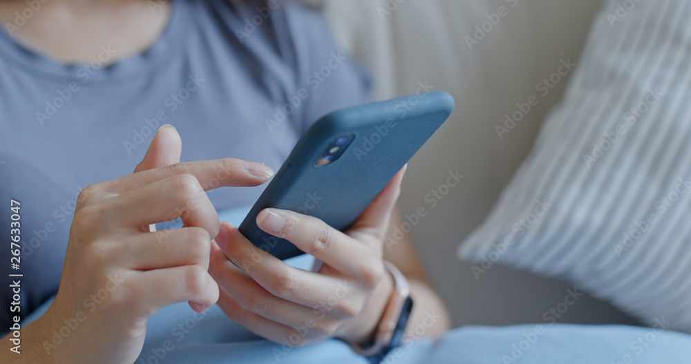 Close up of woman use mobile phone at home Close up of woman use mobile phone at home