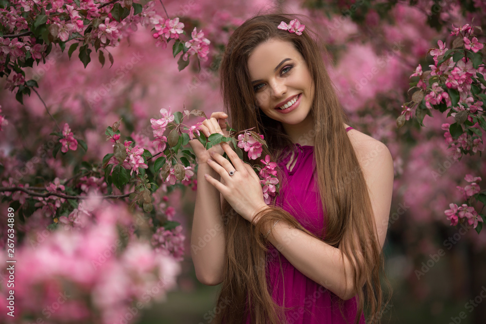 Beautiful girl in blossom apple garden with pink flowers, spring time Beautiful girl in blossom apple garden with pink flowers, spring time