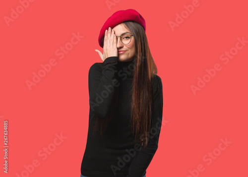 Young artist woman shouting happy and covering face with hand