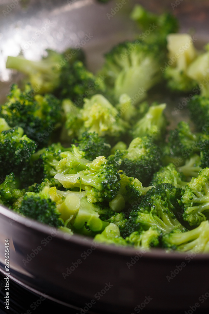 young woman in a gray apron roasts cauliflower broccoli young woman in a gray apron roasts cauliflower broccoli